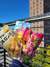 Our Mascot Mix team member holds up the "Melon Pan Cookies", "Deliciously Moist Strawberries snack", and Noginon postcard!