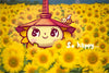 An illustration of Noginon the sunflower girl standing in a field of... sunflowers. A happy bee rests on her Hoffman Kiln hat. The words "So Happy..." are written in English.
